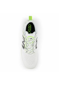 White athletic shoe with perforated upper, black accents, and neon green laces. Features a pull tab and logo on the insole.