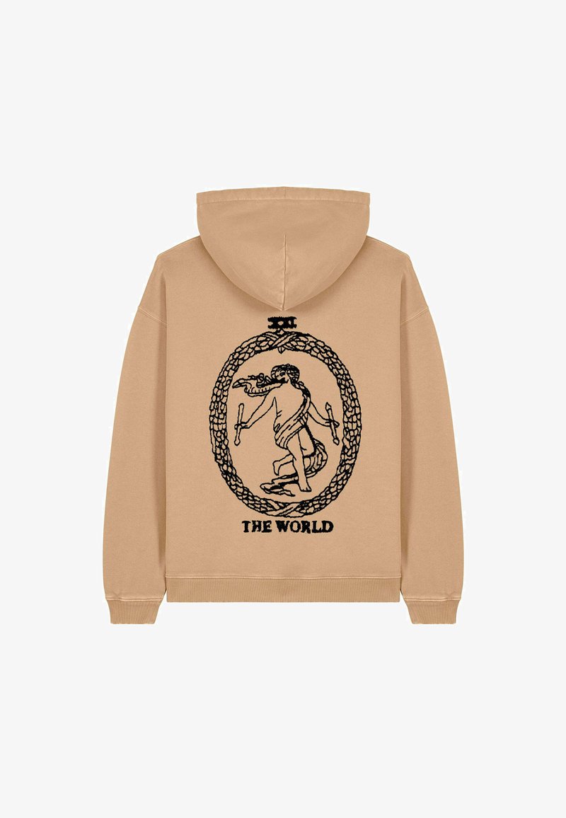 Sweat-shirt beige à capuche avec un design graphique noir représentant une figure au sein d'un motif circulaire, le texte indique "LE MONDE." Texture douce.