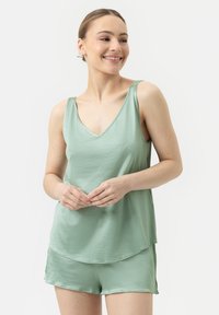 Mintgroene loungewear-set met een V-hals tanktop en bijpassende shorts, met een zachte textuur en een relaxte pasvorm.