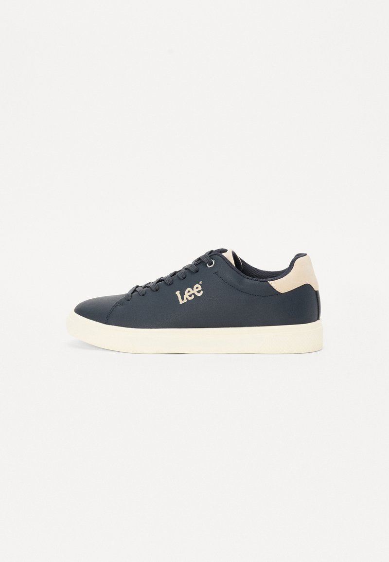Navy blue sneakers made of smooth material with a white sole and light tan accents, featuring shoelaces and a "Lee" logo on the side.