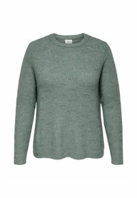 Ljust grön stickad tröja med rund halsringning, långa ärmar och ett strukturerat mönster av hexagoner. Vågig kantdetalj längst ner.