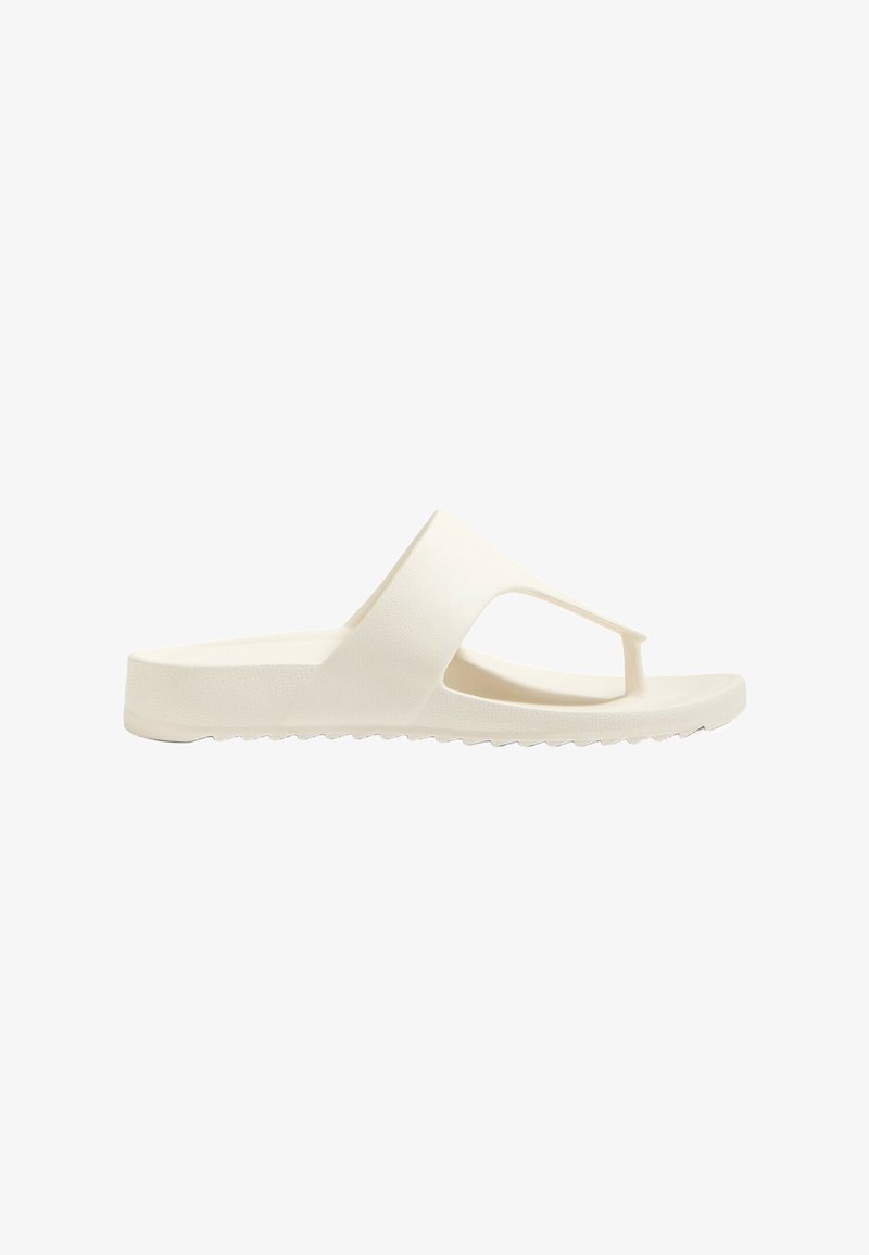 White rubber slide sandal with a textured finish, open toe, and cut-out design. Flat sole with slight grooves for traction.