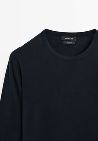 Navy blue cotton long-sleeve shirt with a round neckline; features a soft texture and a label stating "Massimo Dutti" and fabric composition.