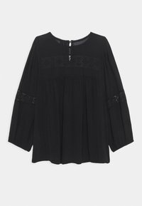 Blouse noire à manches longues avec col rond, dotée de détails en dentelle sur les manches et le corps, coupe ample et fermeture à boutons au dos.