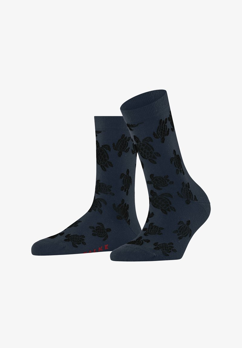Calze blu navy con motivo a tartaruga in nero. Parte superiore a coste, lunghezza media, materiale in misto cotone. Accenti di testo rossi sulla parte inferiore.