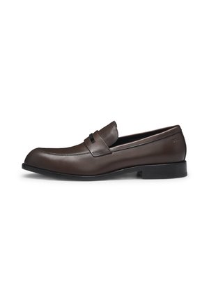 Brown leather loafers with a sleek design, rounded toe, and a decorative band. Features a smooth texture and a low black rubber sole.