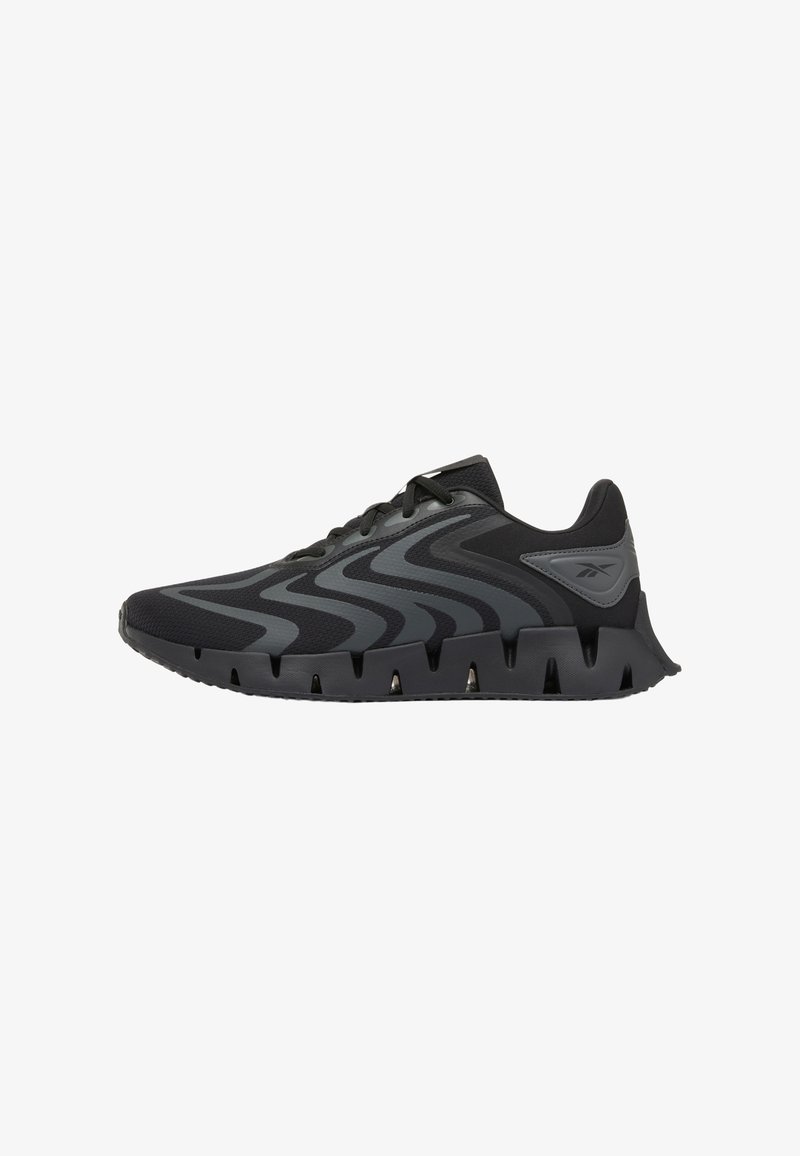 Black and dark gray athletic sneaker with wave pattern overlays, lace-up closure, and segmented sole with cut-out details.