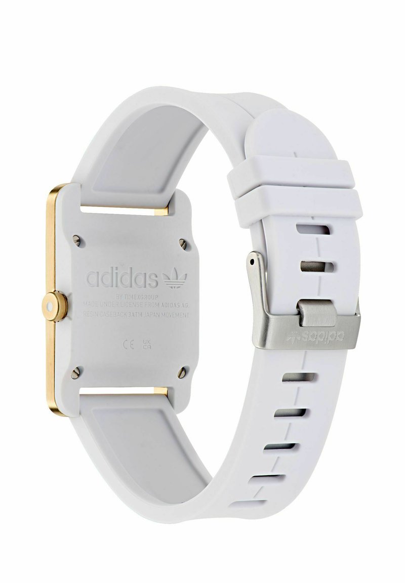 White silicone strap watch with a square gold-tone case, featuring a textured back and stainless steel clasp with an engraved logo.