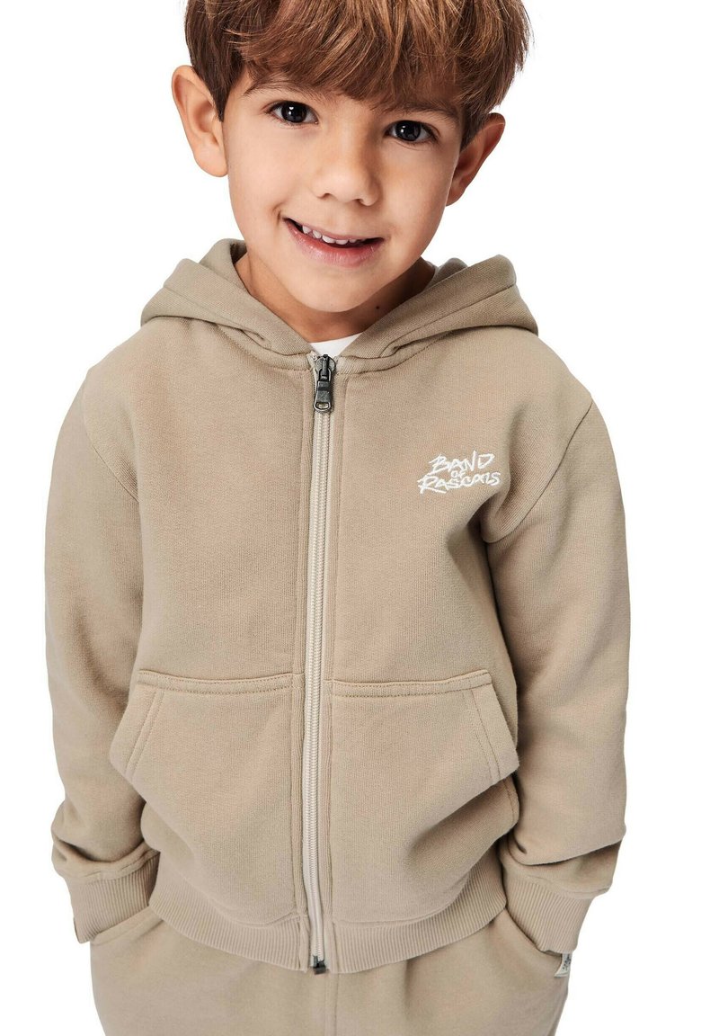 Beige zip-up hoodie med ett framsidesdesign, som har en känguruficka, ribbade mudd samt en mjuk textur. Idealisk för avslappnad klädsel.