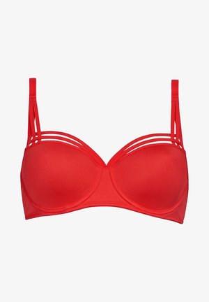 Červená podprsenka s kosticemi, hladkým materiálem a tvarovanými košíčky. Má tři tenké, horizontální popruhy na každém rameni. Uzavřený design vzadu.