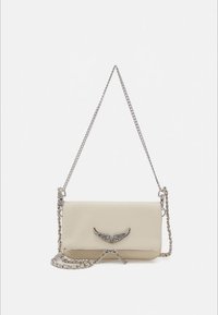 Cream leather crossbody bag with silver chain strap, featuring a wing-shaped metallic accent on the front and a sleek rectangular design.