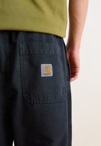 Carhartt WIP JUDD PANT - Trousers - black stone dyed