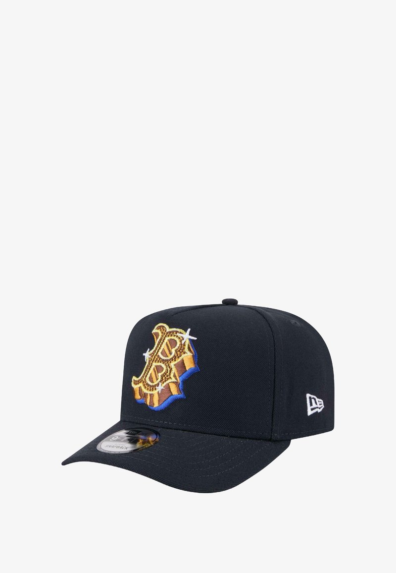Navy cap with a structured design, featuring a prominent golden embroidered logo on the front, and a flat brim for sun protection.