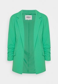Blazer verde con una textura suave, dos bolsillos delanteros y un diseño de solapa con muesca. Cuenta con mangas largas y cierre abierto.