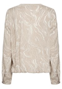 Blouse beige avec un motif blanc tourbillonnant, manches longues, encolure ronde et coupe décontractée à l'ourlet, fabriquée dans un tissu lisse et léger.