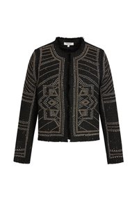 Musta tweed-takki, jossa on geometrisiä hopeanvärisiä niittikuvioita, pitkät hihat ja fringet värähtäjät kauluksessa, etureunoissa ja helmassa.