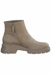 Bottine beige à semelle épaisse, fermeture éclair latérale et tige en cuir lisse.