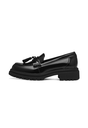 Mocasines de charol negro con una suela de goma negra gruesa, que cuentan con un borlas decorativa y un acabado suave y pulido.