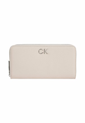 Portafoglio in vera pelle rosa chiaro con finitura testurizzata, caratterizzato da un logo "CK" in argento. Chiusura con zip nella parte superiore e forma rettangolare elegante.