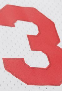 Tessuto a rete bianco con il numero "3" rosso, caratterizzato da bordi angolari, dettagli di cucitura e piccole perforazioni per la ventilazione.