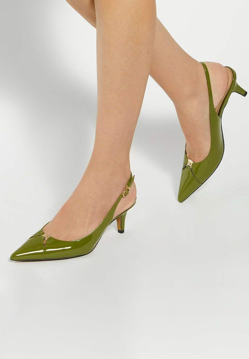 Green patent leather slingback heels with a pointed toe, small heel, and gold hardware detail at the front, showcasing a sleek design.