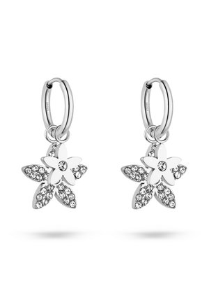 Pair of silver hoop earrings with dangling five-petal flower charms adorned with clear round crystals on petals and center.