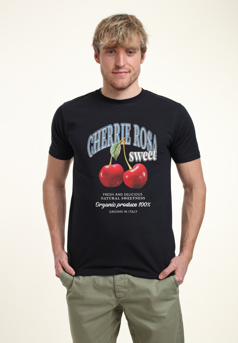 Camiseta de algodón negra con un gráfico vibrante de cerezas y texto que dice "CHERRIE ROSA sweet" con acentos en blanco y azul.