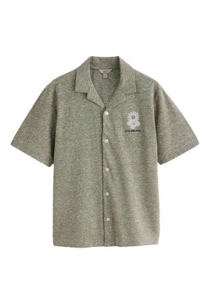 Chemise grise à manches courtes avec boutons et col, brodée de tournesols blancs et texte « LUZ DEL SOL » sur la poitrine gauche.