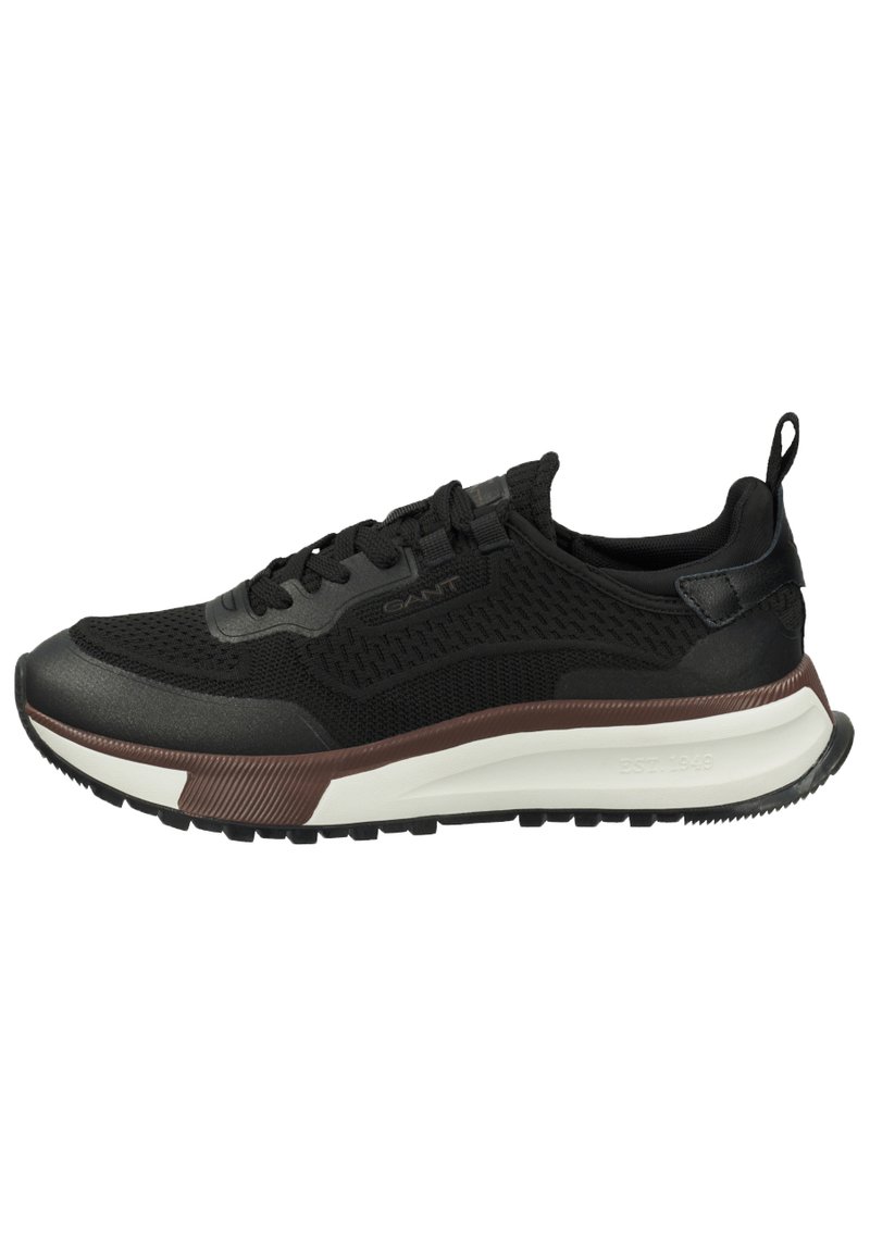 Black athletic sneaker with mesh upper, rubber sole, and accent in dark brown. Features lacing system and textured design.