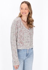 Cardigan grigio a maglia texturizzata con punti colorati, scollo a V e chiusura con bottoni. Lunghezza cropped e maniche aderenti.