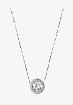 Collier en chaîne argentée avec pendentif rond comportant un cristal clair central et "Michael Kors" gravé autour.