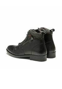 Bottes basses en cuir noir avec doublure grise texturée, lacets à l'avant, fermeture éclair latérale, et semelles en caoutchouc pour une meilleure adhérence. Comprend une languette à l'arrière.