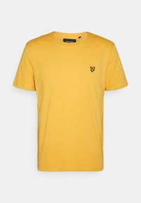 Camiseta de algodón amarilla de manga corta con cuello redondo y un pequeño logo negro bordado en el lado izquierdo del pecho. Acabado texturizado.