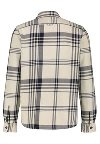 Chemise à manches longues de couleur crème avec un motif à carreaux noir et gris, poignets boutonnés et une couture en forme de chas à l'arrière.