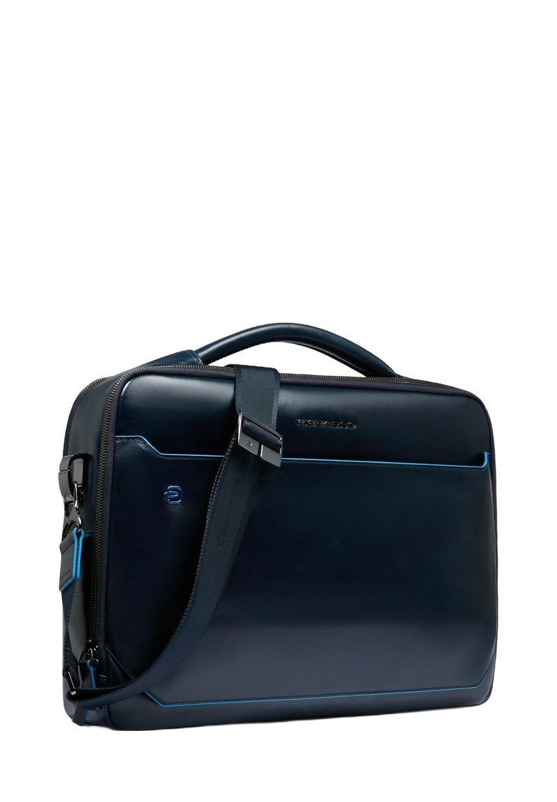 Borsa a tracolla in pelle blu scuro con una texture liscia, dotata di una tracolla removibile e cuciture blu a contrasto.