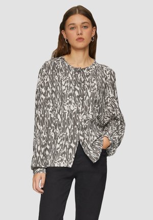 Blouse à manches longues dans un motif abstrait monochrome, dotée d'un col rond, de boutons sur le devant et d'une coupe décontractée. Fabriquée en tissu léger.