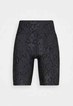 Mustat käärmeennahkakuosiset pyöräilyhousut, jotka on valmistettu joustavasta kankaasta. Niissä on korkea vyötärö ja sileä pinta, jossa on hienovarainen hohde.