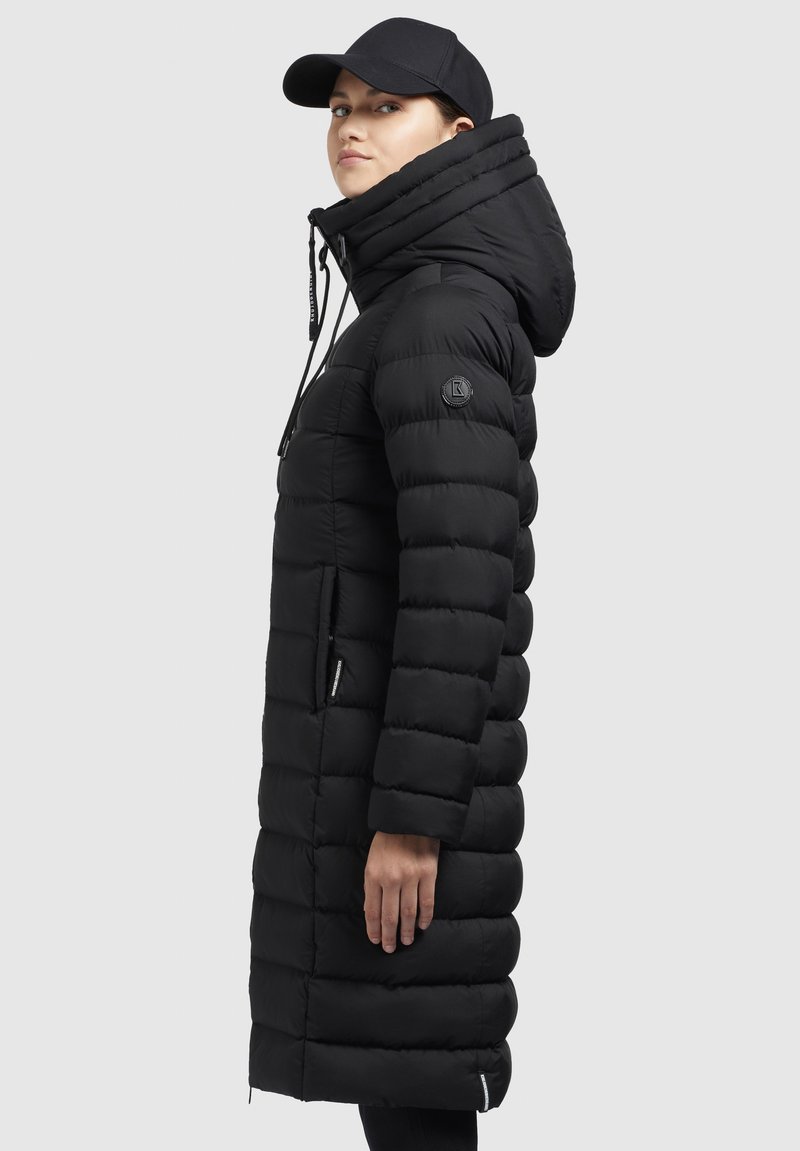 Schwarze Daunenjacke mit hohem Kragen, gerippter Textur, vertikalen Abschnitten und einem Reißverschluss. Verfügt über eine abnehmbare Kapuze und Seitentaschen.