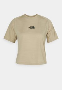 Beige kortärmad t-shirt i lätt material, med en svart logotyp på bröstet och en avslappnad, cropped design.