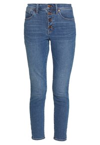 Vysoké skinny džíny středně modré barvy z džínoviny s pěti knoflíky, předními kapsami a čistým zakončením u kotníků.