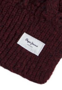 Strikket bordeaux hue med et struktureret mønster, med et hvidt mærke hvor der står "Pepe Jeans London" i sort tekst.