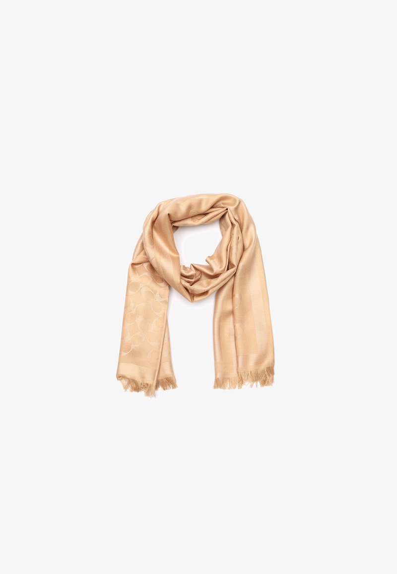 Beige tørklæde lavet af blødt stof, med et subtilt cirkulært mønster og frynsede kanter, arrangeret i en overlappende sløjfe.