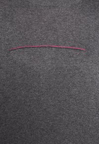 Gray knitted sweater with a smooth texture. Features a horizontal pink stitched line across the chest area. Classic round neckline.