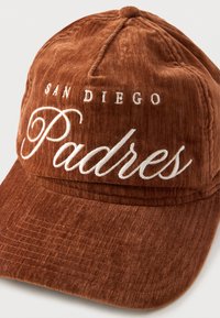 Brown corduroy baseball cap featuring embroidered text "SAN DIEGO Padres" in white. Structured design with a curved visor and adjustable back.