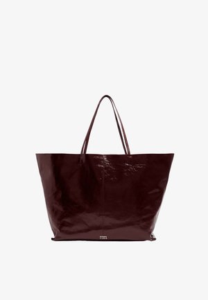 Burgundia nahkakott läikiva viimistlusega, laia avatud ülemise osaga ja kahe pika käepidemega. Omab minimalismi ja ei sisalda nähtavat riistvara.