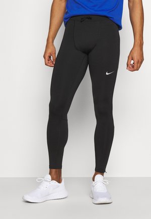 Leggings deportivos negros hechos de tela elástica, con una cintura ajustable y un pequeño logotipo blanco de Nike en el muslo izquierdo.