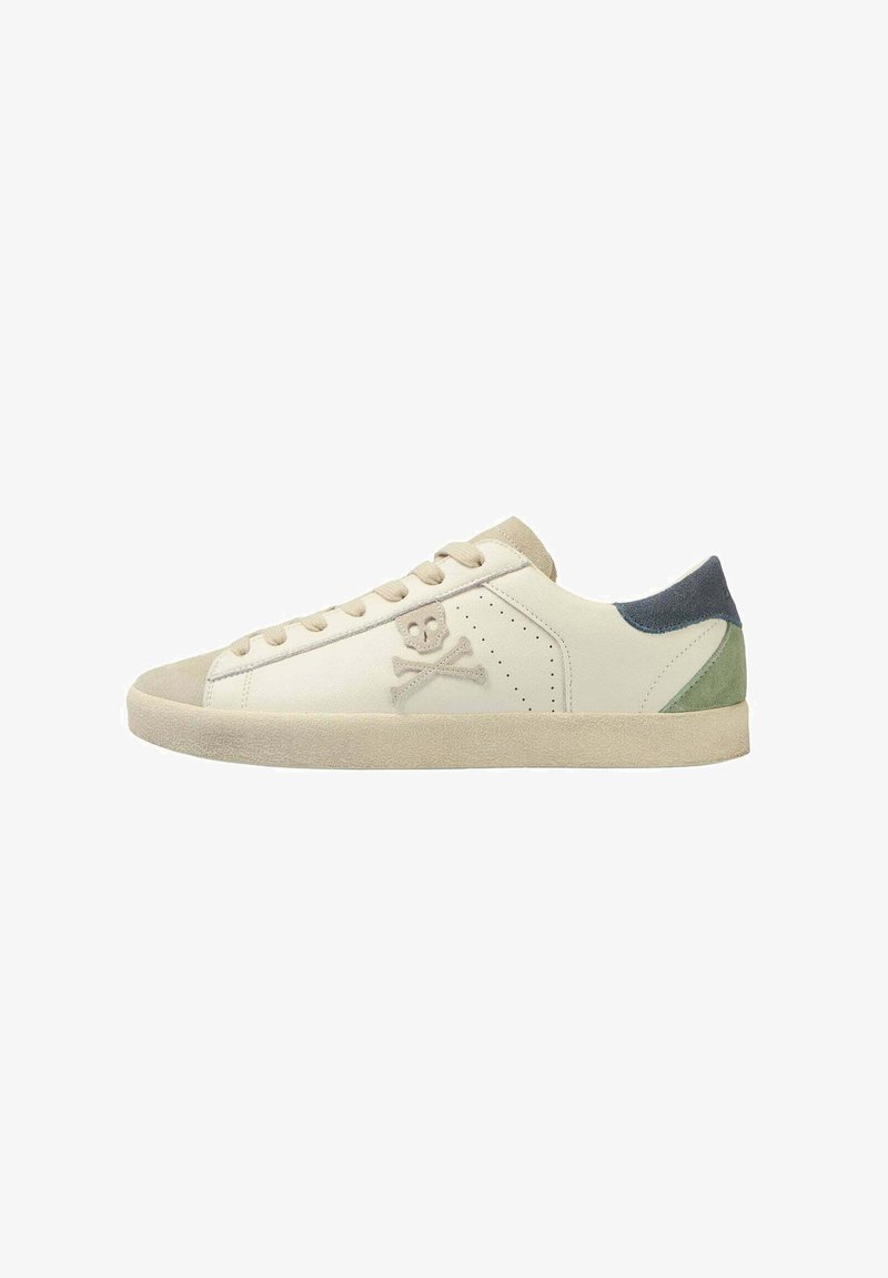 White leather sneaker with light gray suede accents, green and navy heel tabs, and a skull and crossbones logo. Plain toe cap, lace-up design.