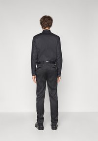 KARL LAGERFELD TROUSERS COSMOS - Suit trousers - black