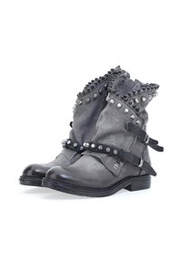 Grey leather ankle boots featuring studded accents, adjustable straps, a rounded toe, and a textured finish with a low stacked heel.