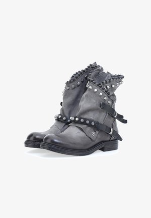 Grijze leren enkelboots met metalen studs, verstelbare banden, een ronde neus en een gestructureerde afwerking met een lage gestapelde hak.